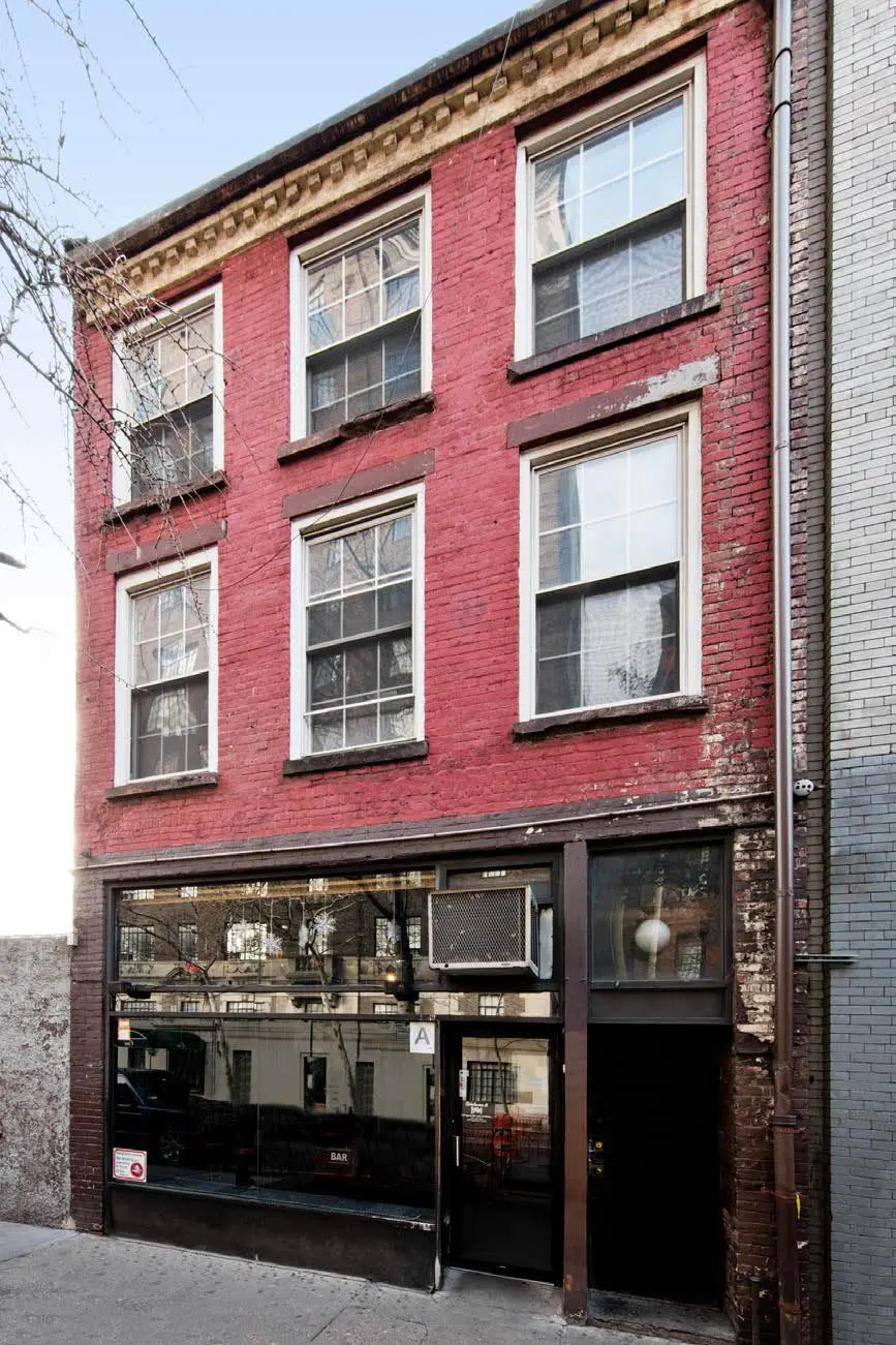 Three-story red brick building exterior.