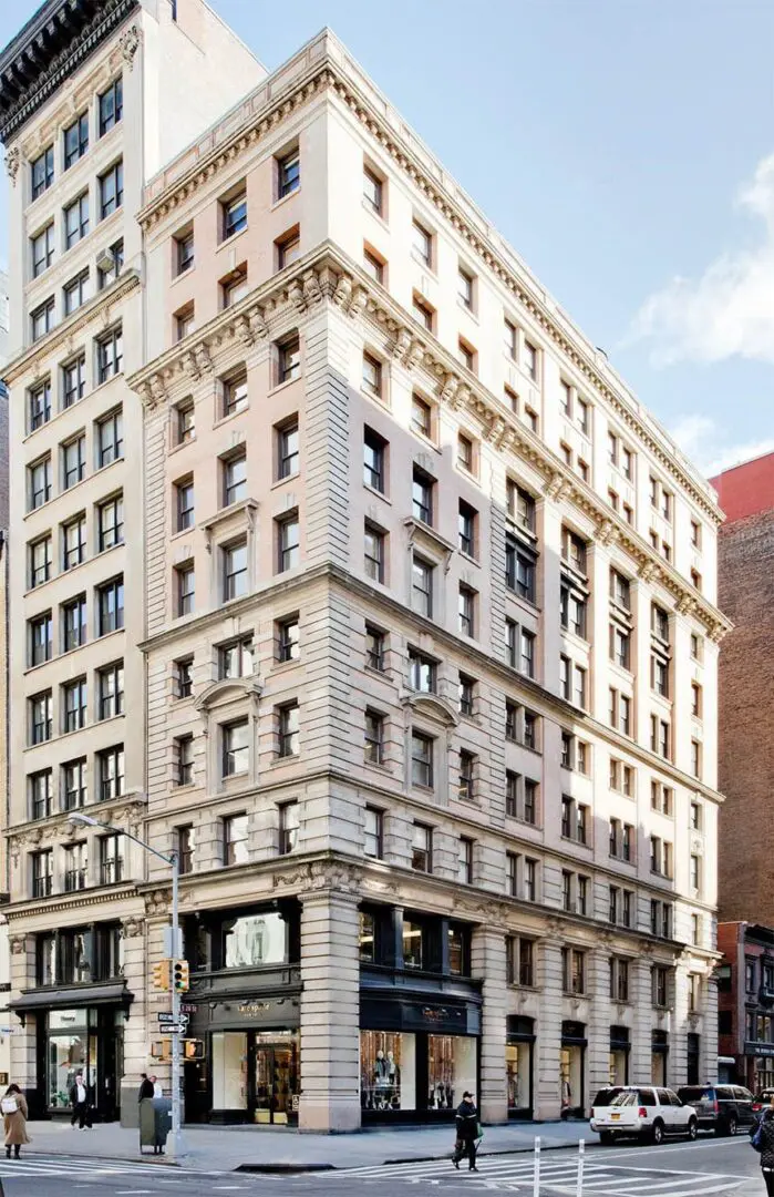 Historic multi-story building on city street corner.