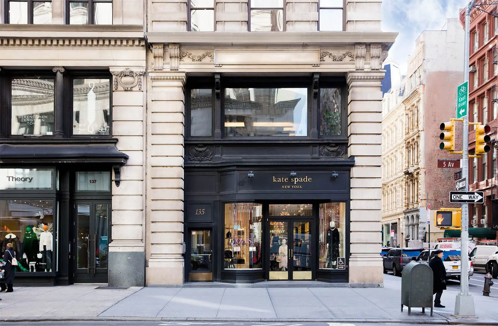 Storefront of Kate Spade in urban setting.
