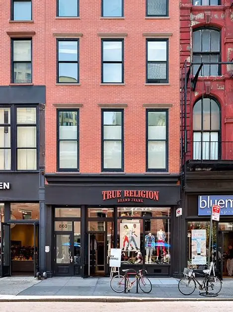 Brick building with storefront and bicycles outside.