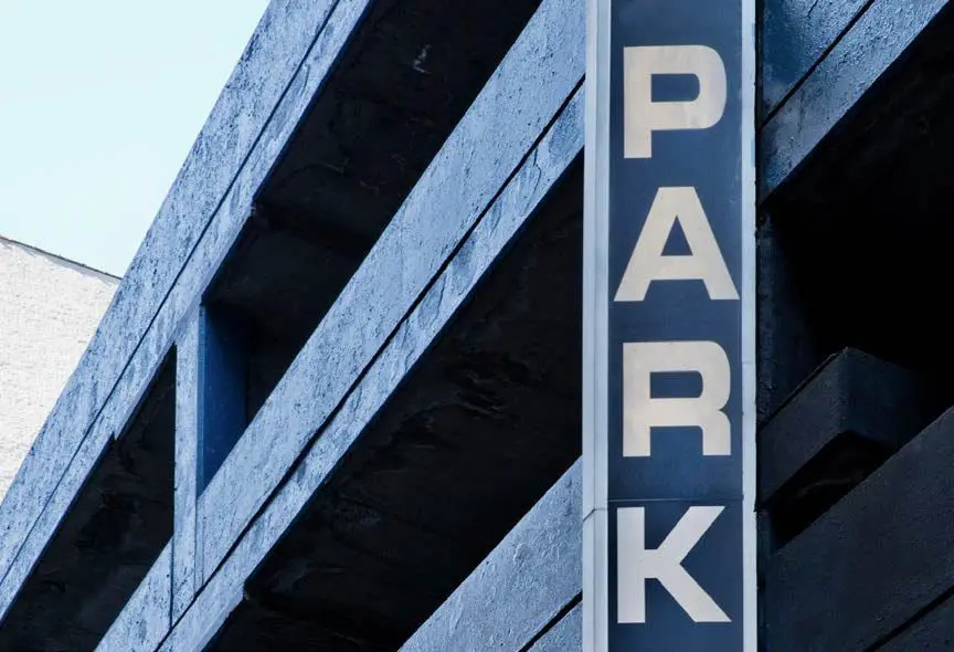 Parking garage with large "Park" sign.