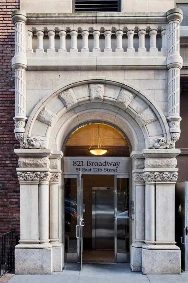 Ornate stone building entrance with archway.