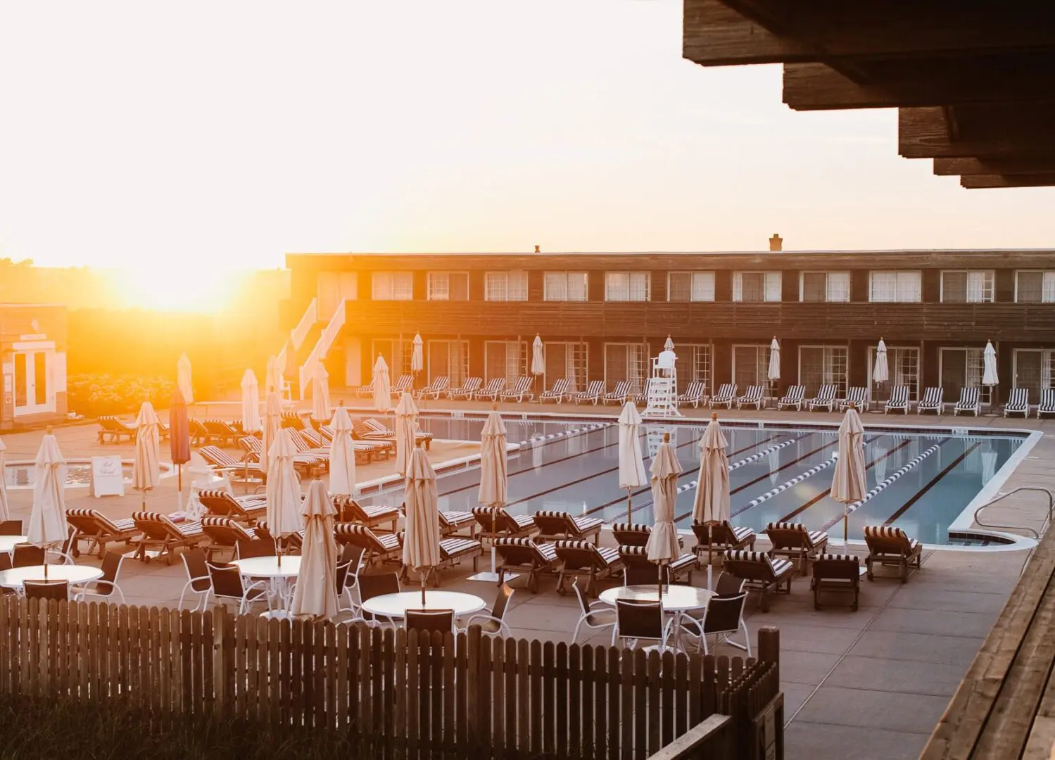 Sunlit pool area with lounge chairs.
