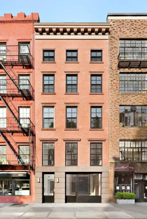 Red brick building with multiple windows.