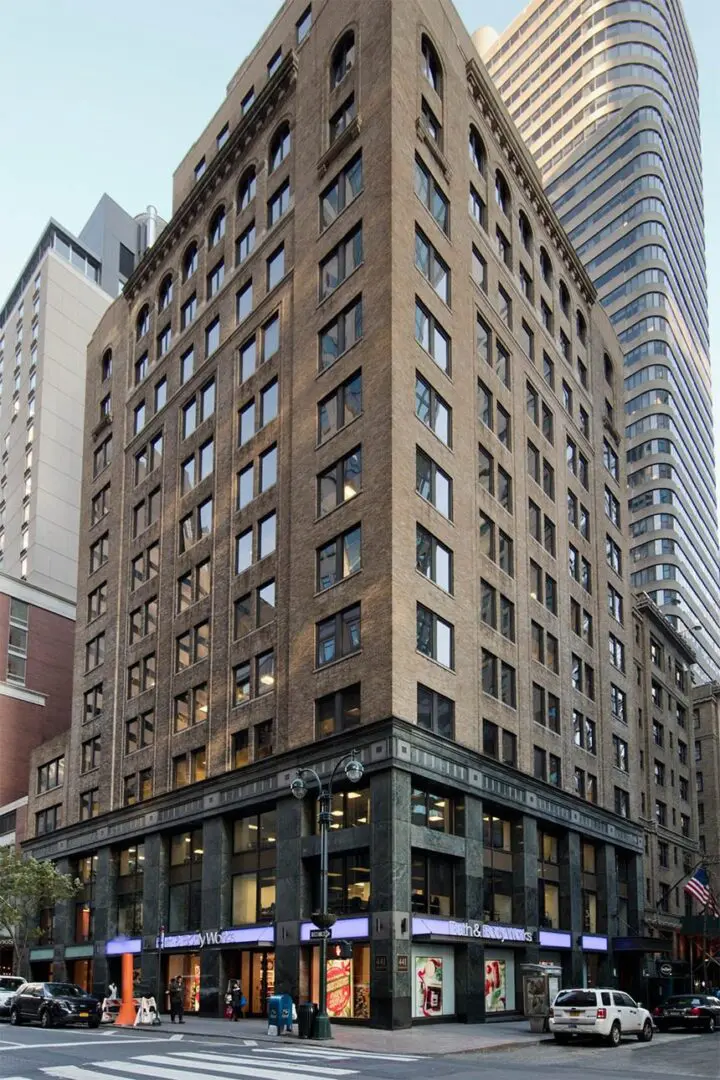 Tall urban building with street-level shops.
