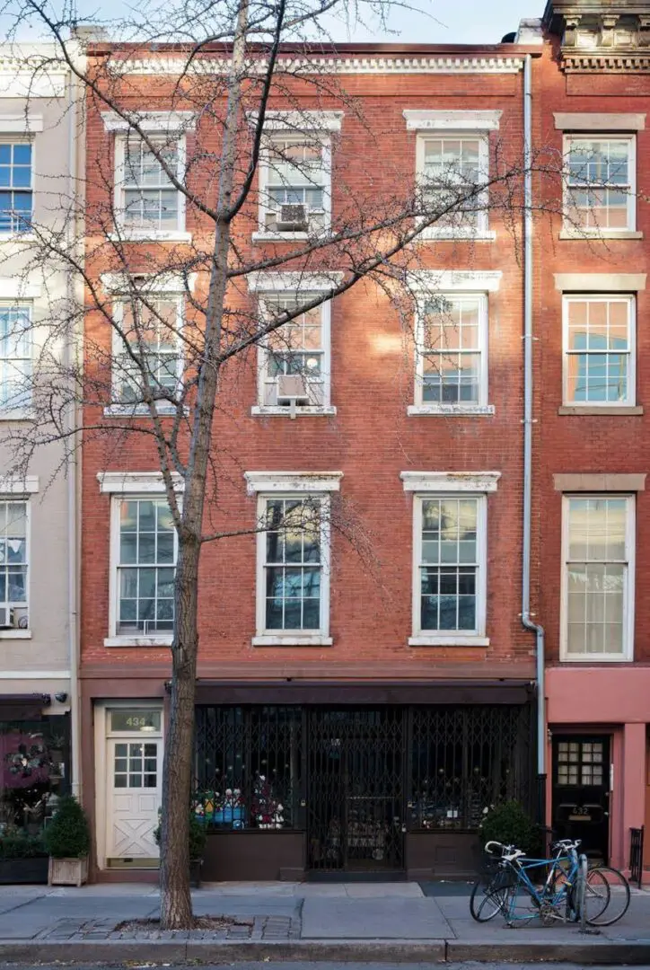 Red brick building with bicycles outside.